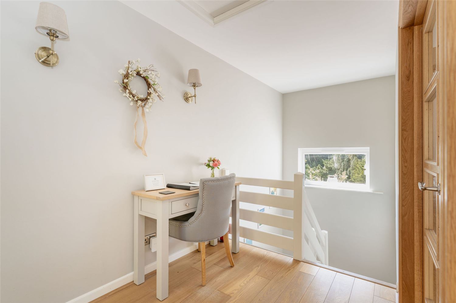 The modern entrance hall with desk and stairs down to the lower ground living and bedrooms