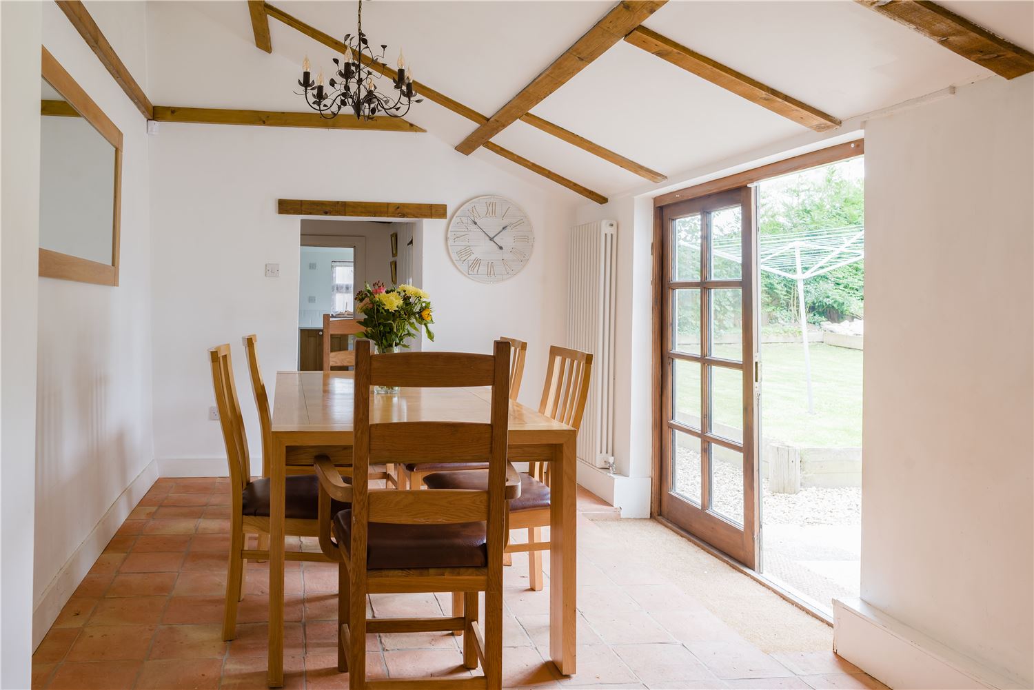 Vaulted ceiling dining area that can seat up to 8 and leads straight out to the garden.